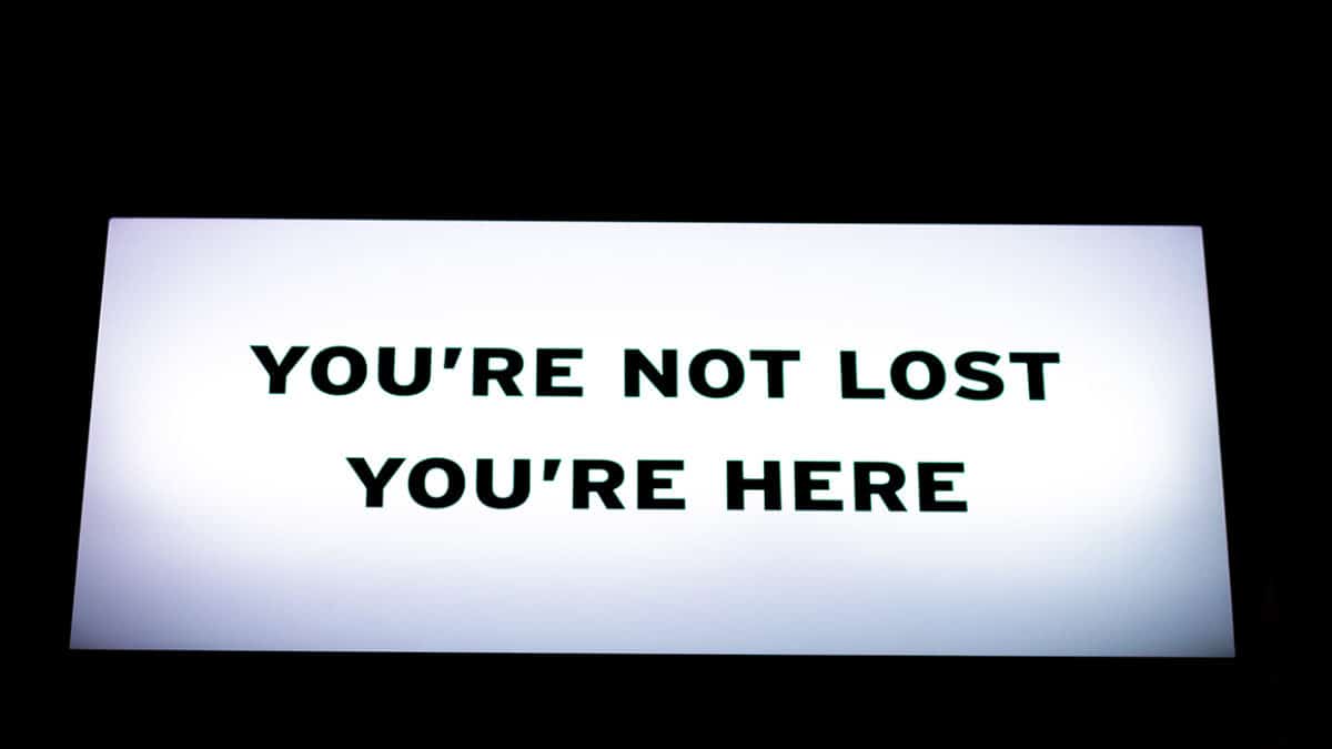 Sign That Says "You're Not Lost. You're Here."