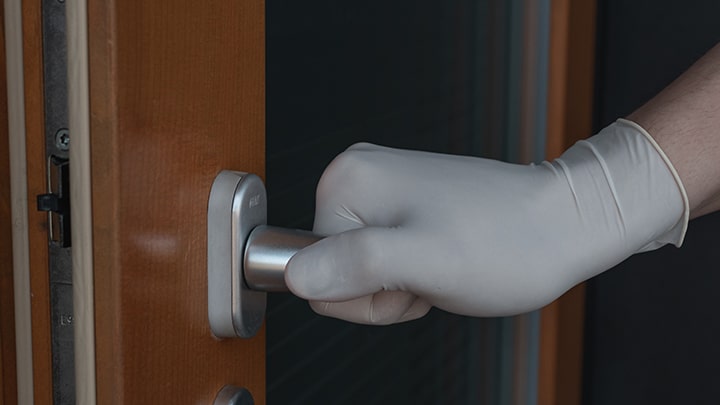 Gloved Hand Opening Door