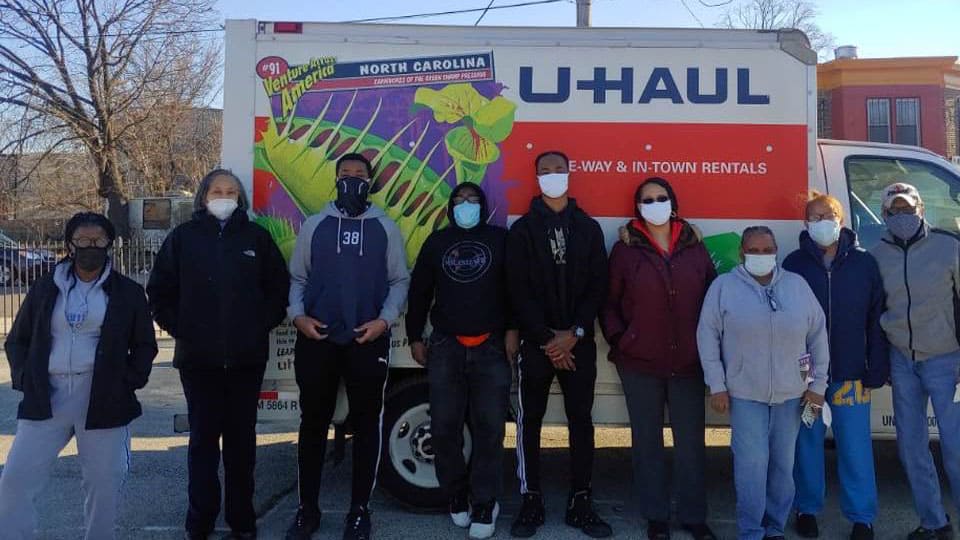 Believers Bible Fellowship Volunteers Standing In Front Of UHaul Truck In School Yard