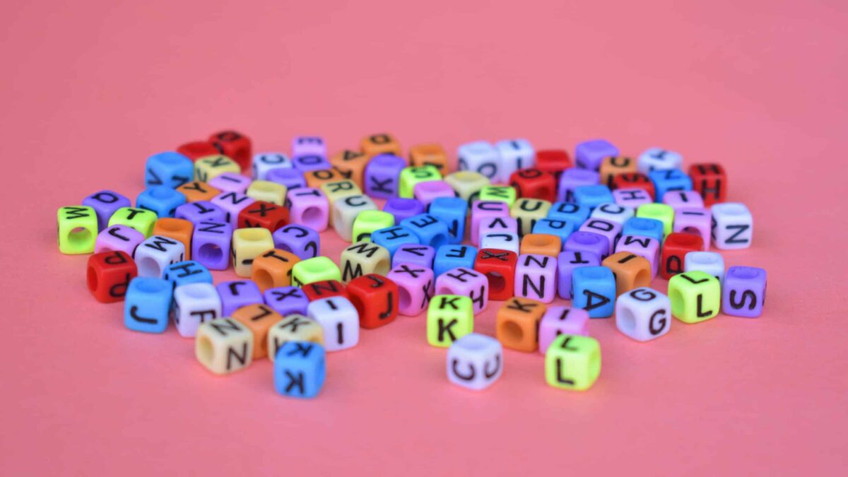 Colorful Alphabet Dice On A Pink Background